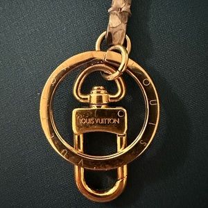 Louis Vuitton snake skin bag charm.